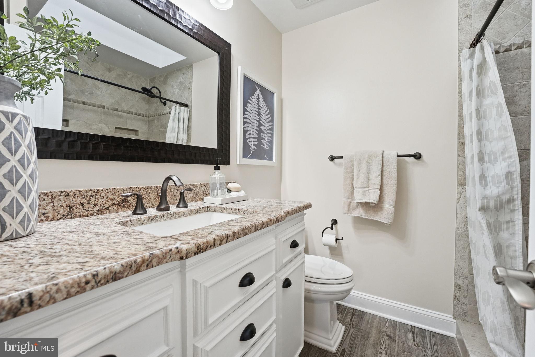 9115 Northedge Drive Springfield, VA 22153 - Photo 40 of 55 a bathroom with a granite countertop sink toilet and shower