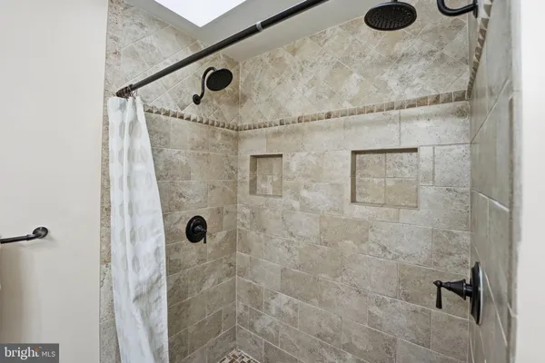 a large bed sitting in a bedroom next to a cabinet