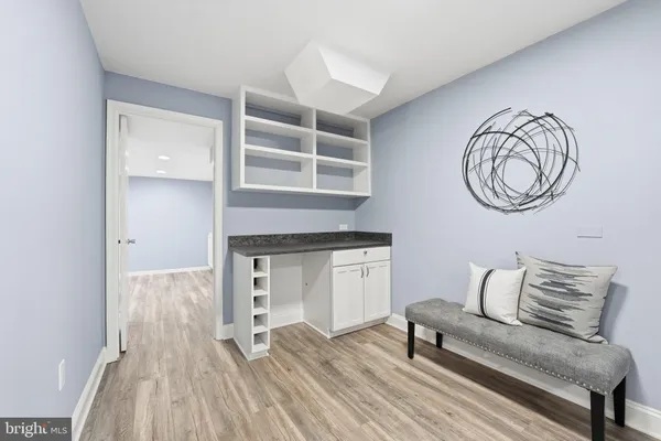 a utility room with dryer washer and empty racks