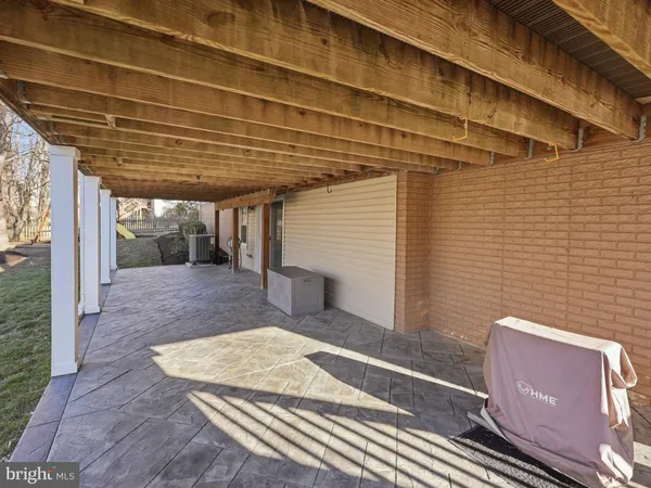 a view of a house with a small yard and wooden fence