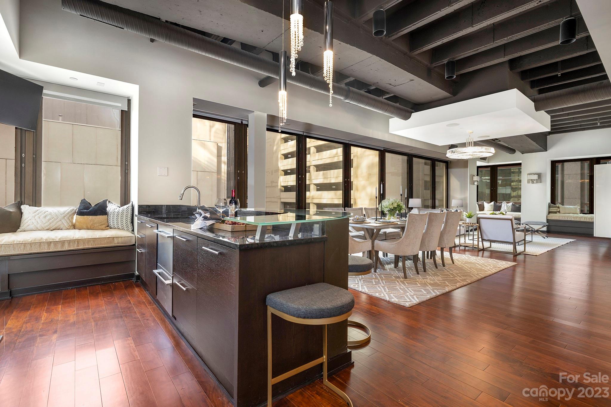139 South Tryon Street, Unit 3B Charlotte, NC 28202 - Photo 11 of 21 a living room with couches a table and chairs with wooden floor