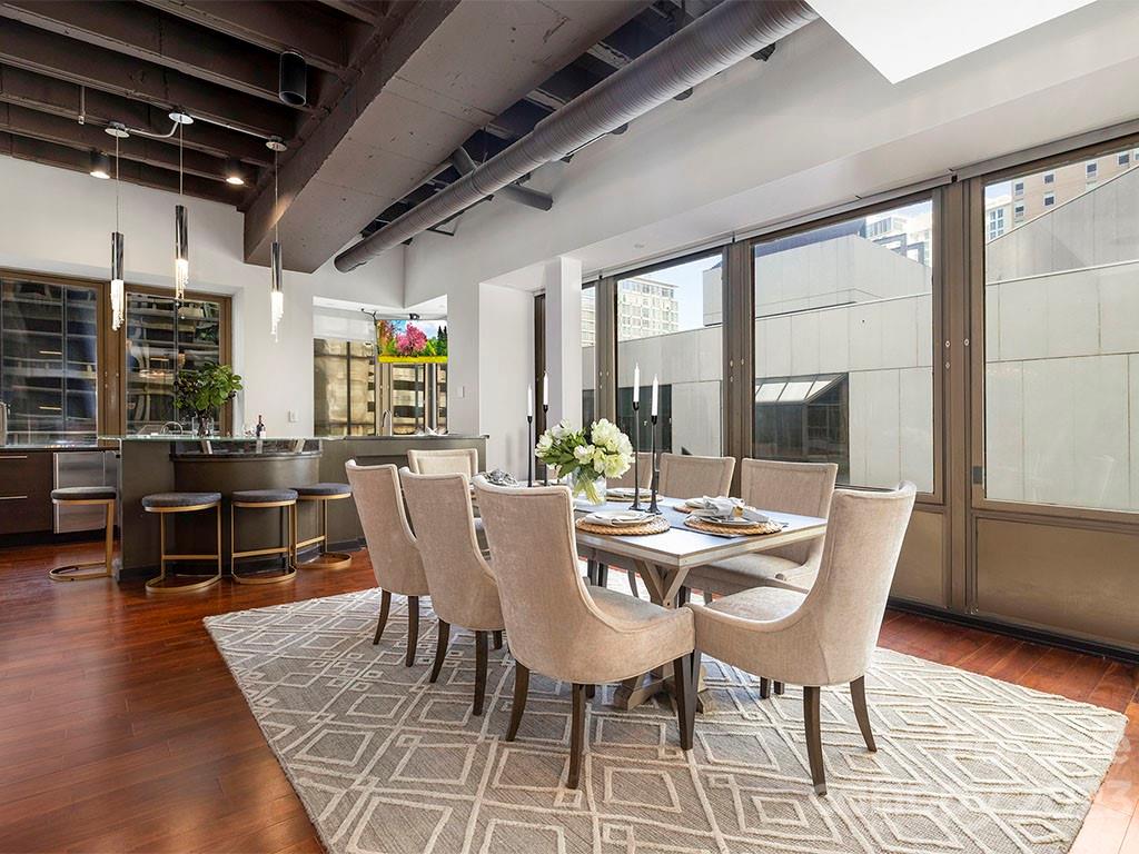 139 South Tryon Street, Unit 3B Charlotte, NC 28202 - Photo 12 of 21 a dining room with furniture window and wooden floor