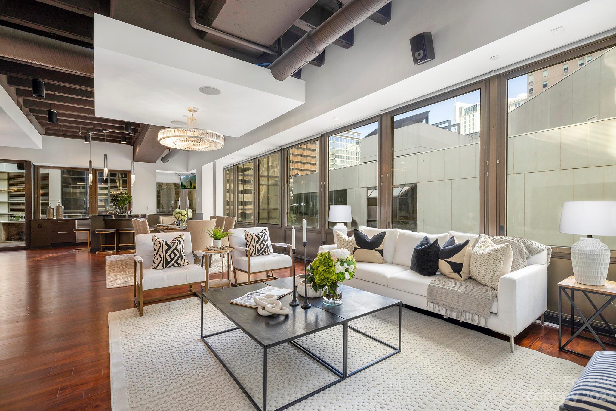 139 South Tryon Street, Unit 3B Charlotte, NC 28202 - Photo 13 of 21 a living room with furniture and a large window