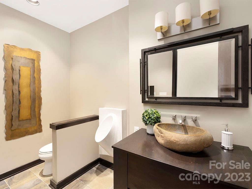 139 South Tryon Street, Unit 3B Charlotte, NC 28202 - Photo 16 of 21 a bathroom with a sink and a mirror