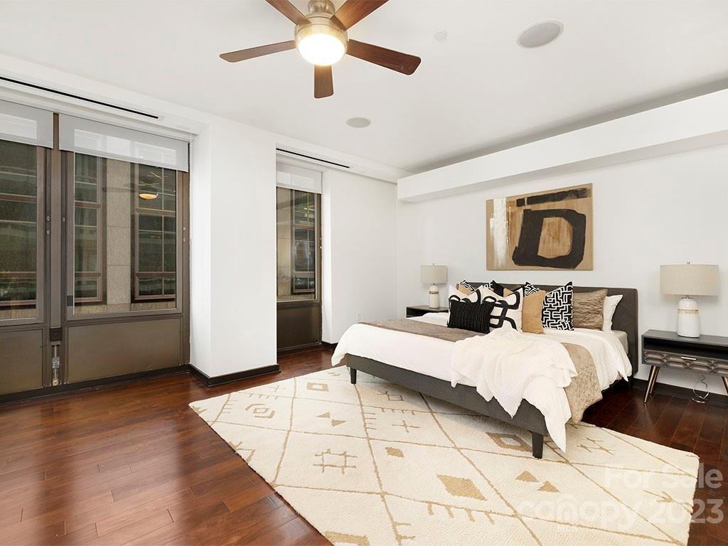 139 South Tryon Street, Unit 3B Charlotte, NC 28202 - Photo 17 of 21 a bedroom with a bed and a large window