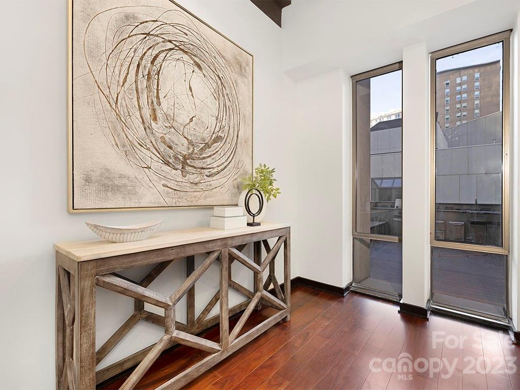 139 South Tryon Street, Unit 3B Charlotte, NC 28202 - Photo 3 of 21 a view of an entryway with wooden floor