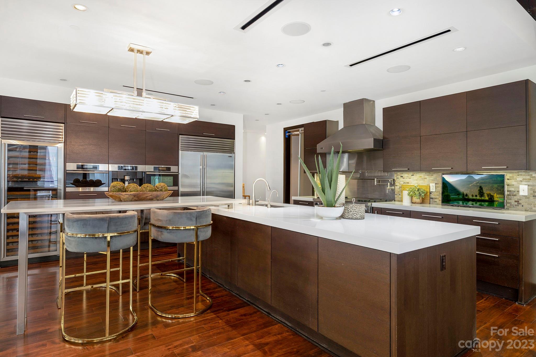 139 South Tryon Street, Unit 3B Charlotte, NC 28202 - Photo 4 of 21 a kitchen with a sink and chairs