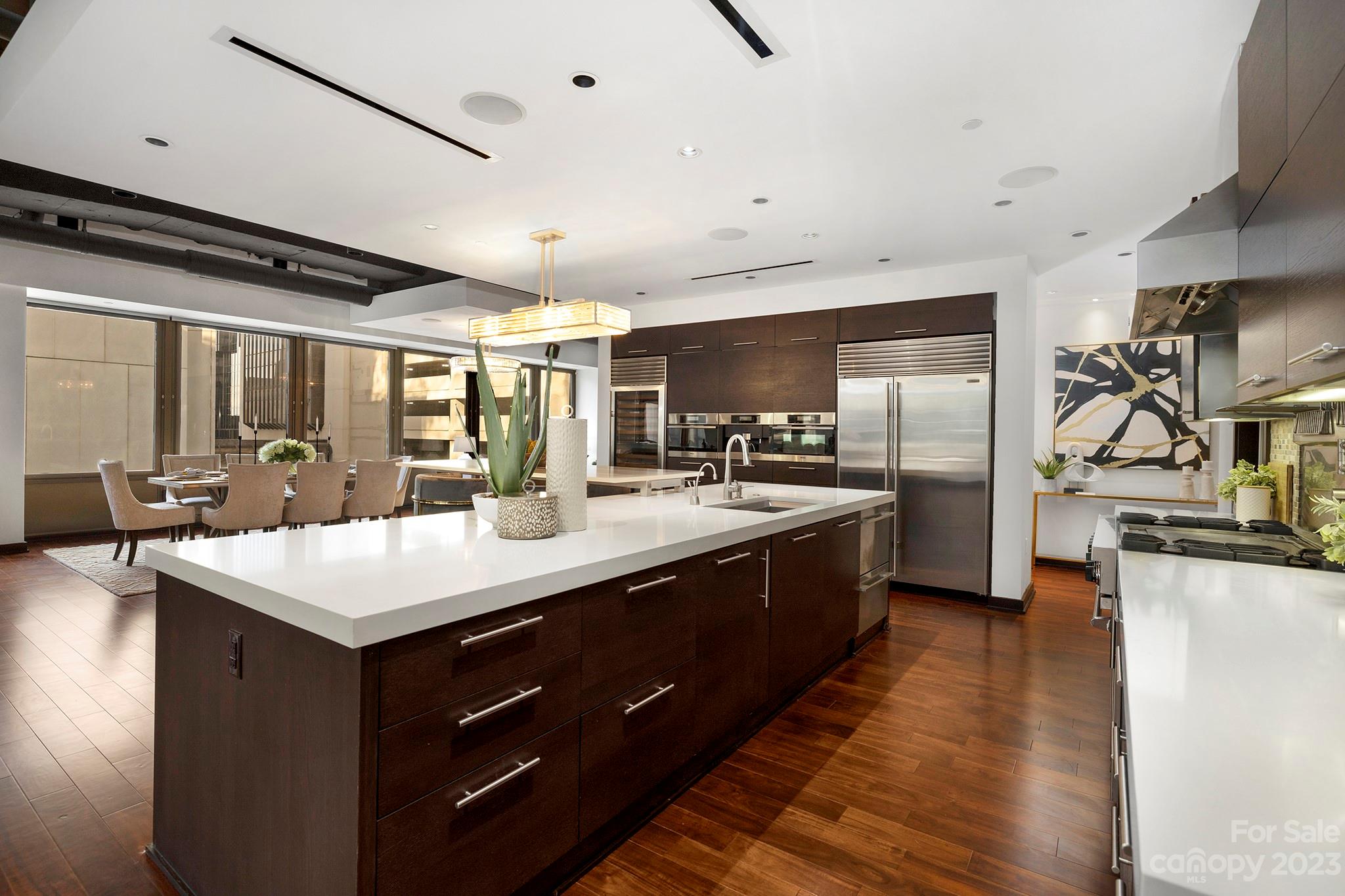 139 South Tryon Street, Unit 3B Charlotte, NC 28202 - Photo 5 of 21 a kitchen with counter top space cabinets and stainless steel appliances