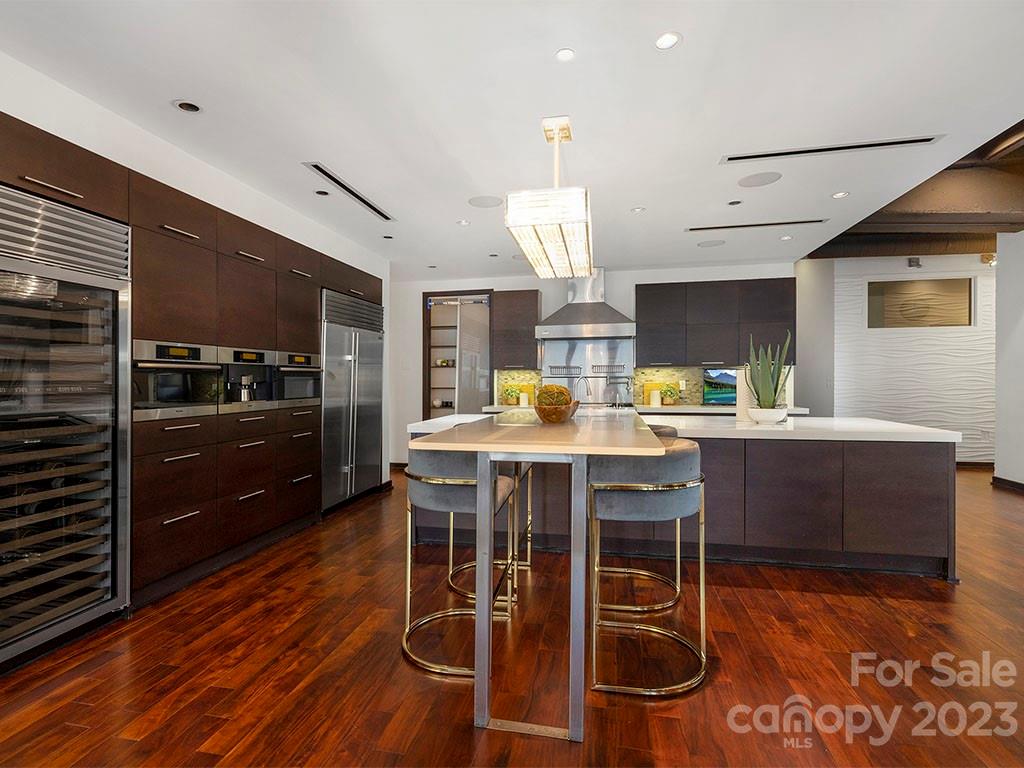 139 South Tryon Street, Unit 3B Charlotte, NC 28202 - Photo 7 of 21 a kitchen with stainless steel appliances kitchen island granite countertop a sink and cabinets