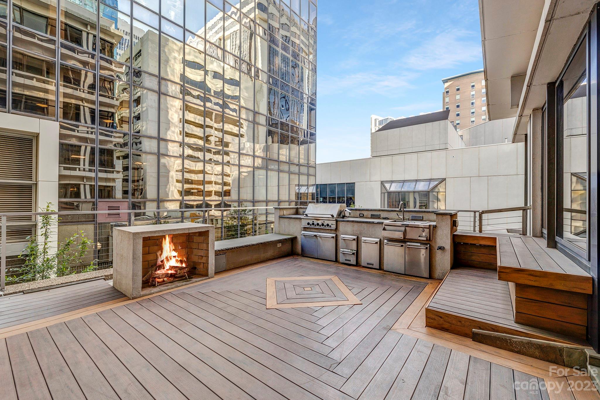139 South Tryon Street, Unit 3B Charlotte, NC 28202 - Photo 8 of 21 a view of outdoor kitchen with seating area and stainless steel appliances