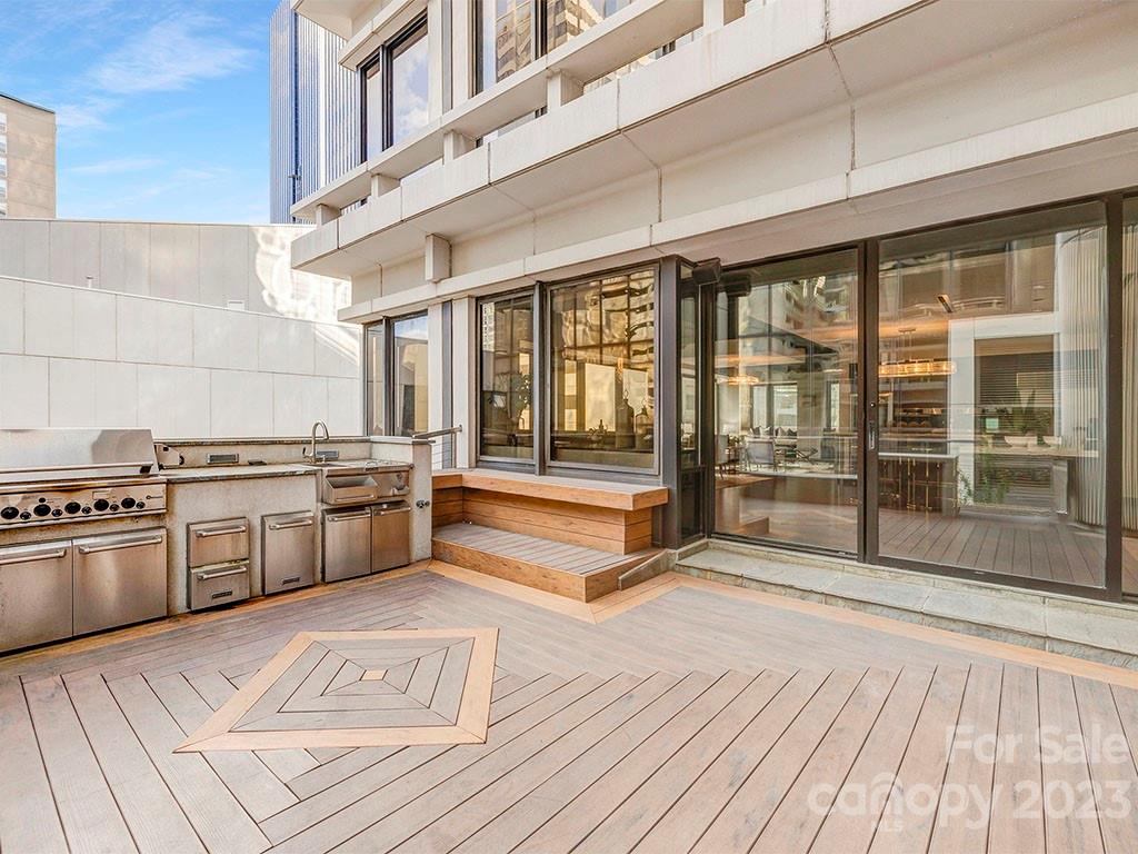 139 South Tryon Street, Unit 3B Charlotte, NC 28202 - Photo 9 of 21 a kitchen with stainless steel appliances granite countertop a stove and a wooden floors
