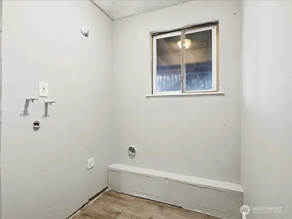 a view of a hallway with wooden floor and entryway