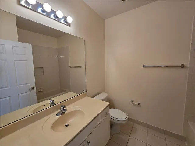a bathroom with a sink vanity and a mirror