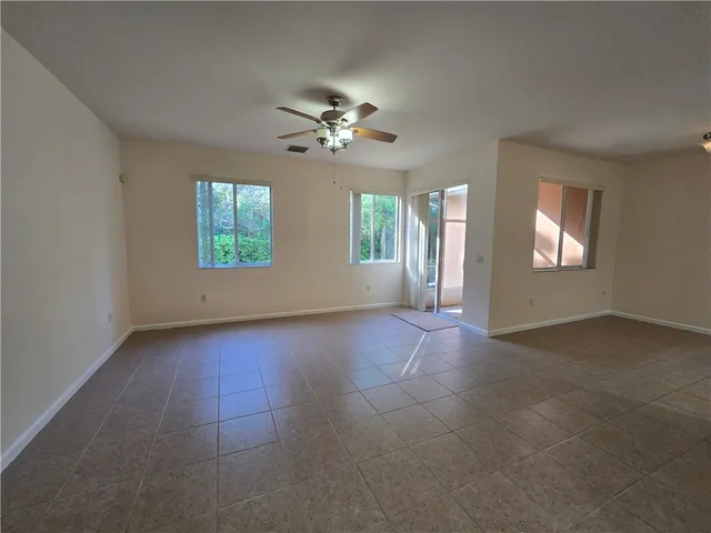 a view of a livingroom with a ceiling fan and window