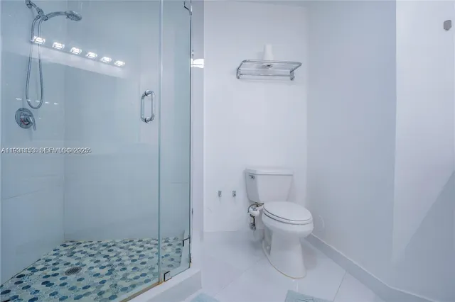 a bathroom with a double vanity sink toilet and a mirror