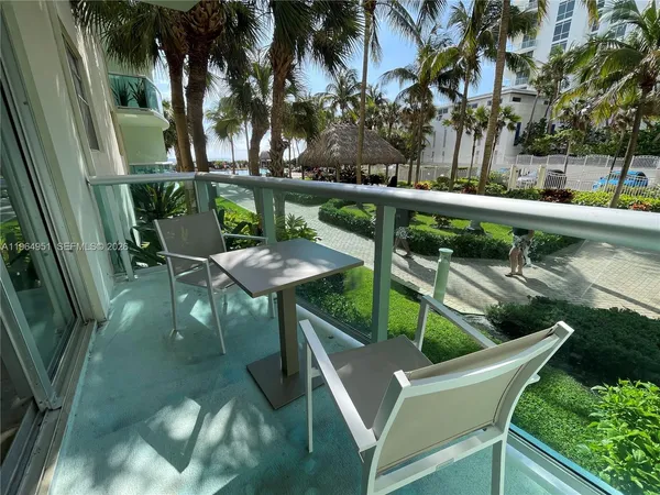 a view of a chairs and table in patio with a lake view