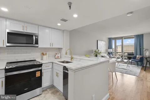 a kitchen with a sink stove and microwave