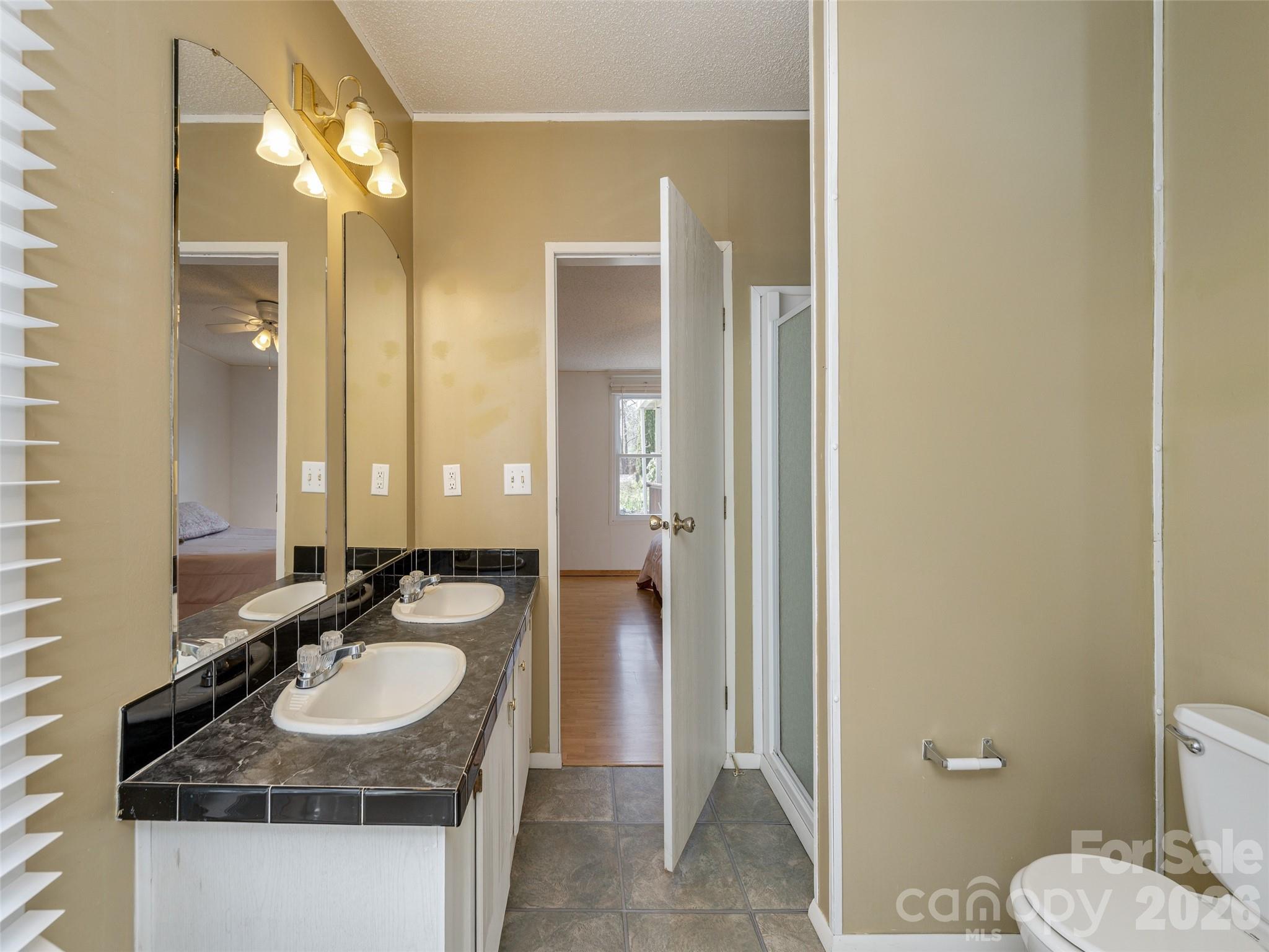 204 Cookies Way Arden, NC 28704 - Photo 12 of 22 a bathroom with a sink and a mirror