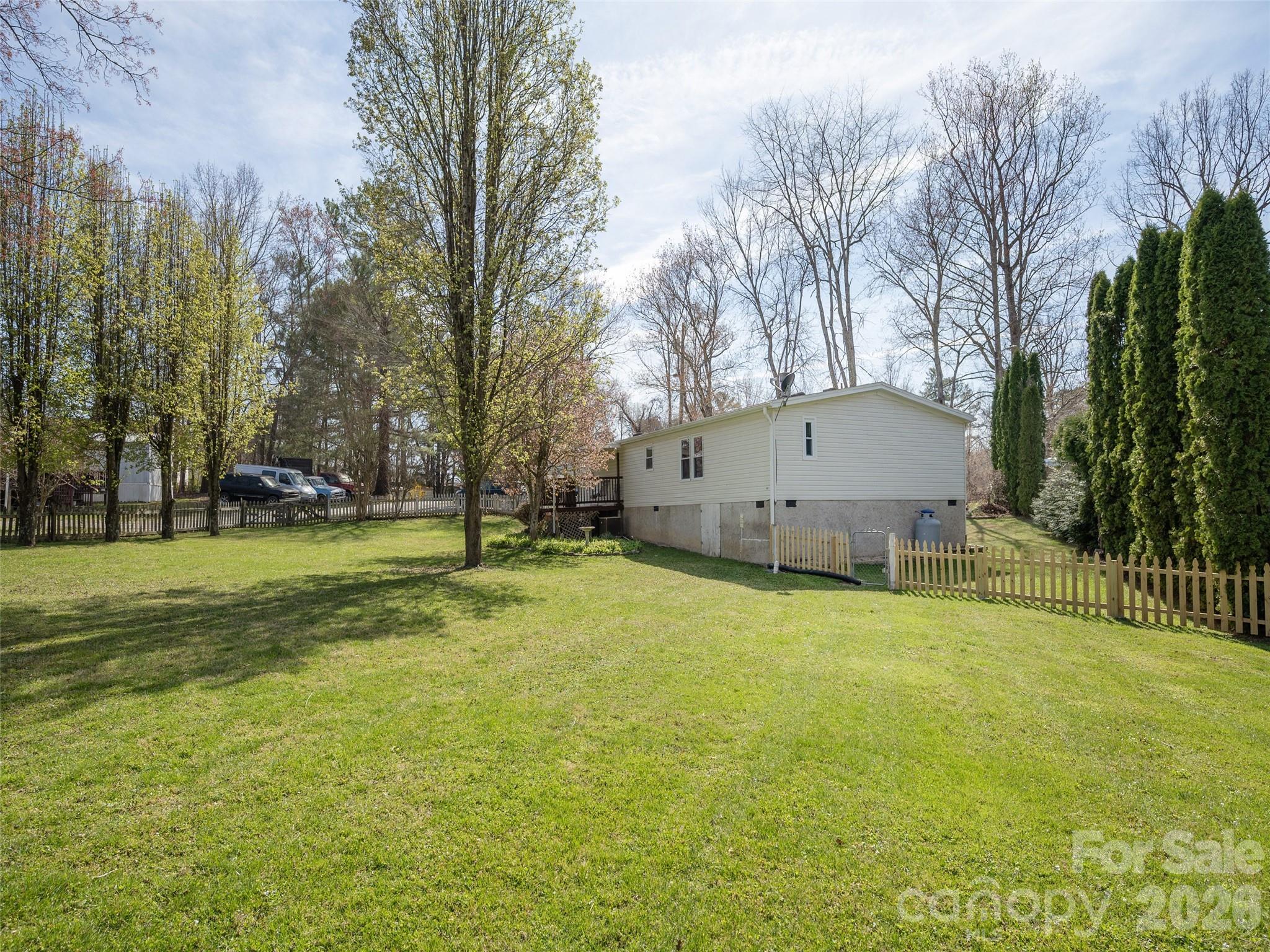 204 Cookies Way Arden, NC 28704 - Photo 19 of 22 a backyard of a house with lots of green space and garden