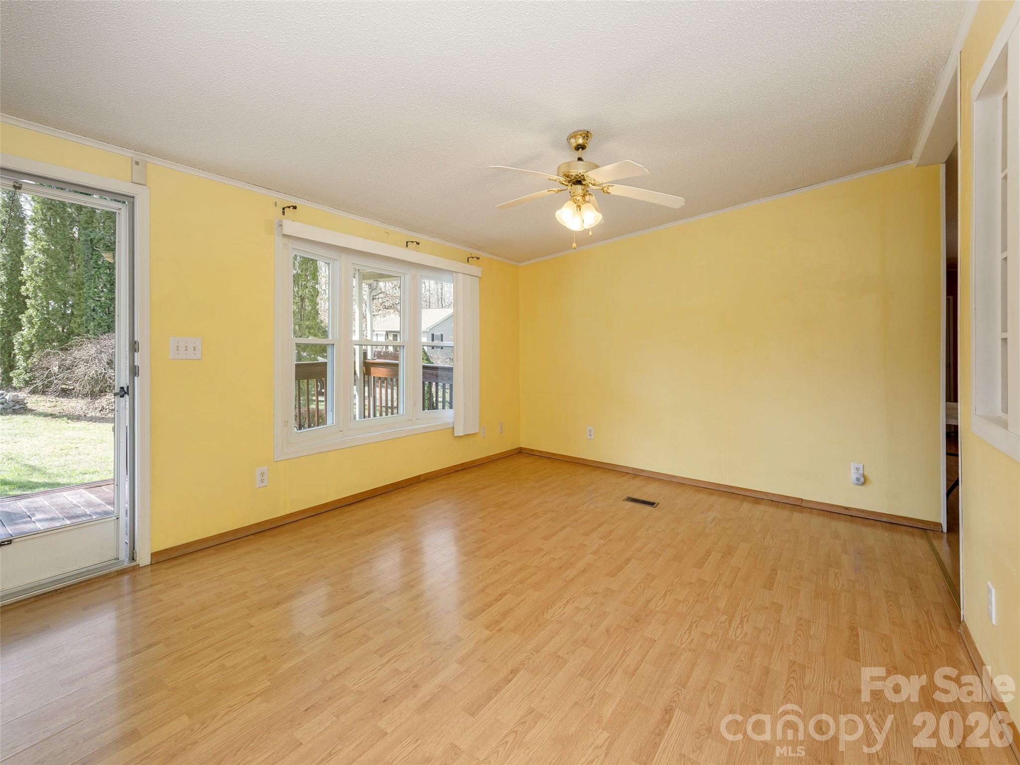 204 Cookies Way Arden, NC 28704 - Photo 3 of 22 a view of an empty room with wooden floor and a window