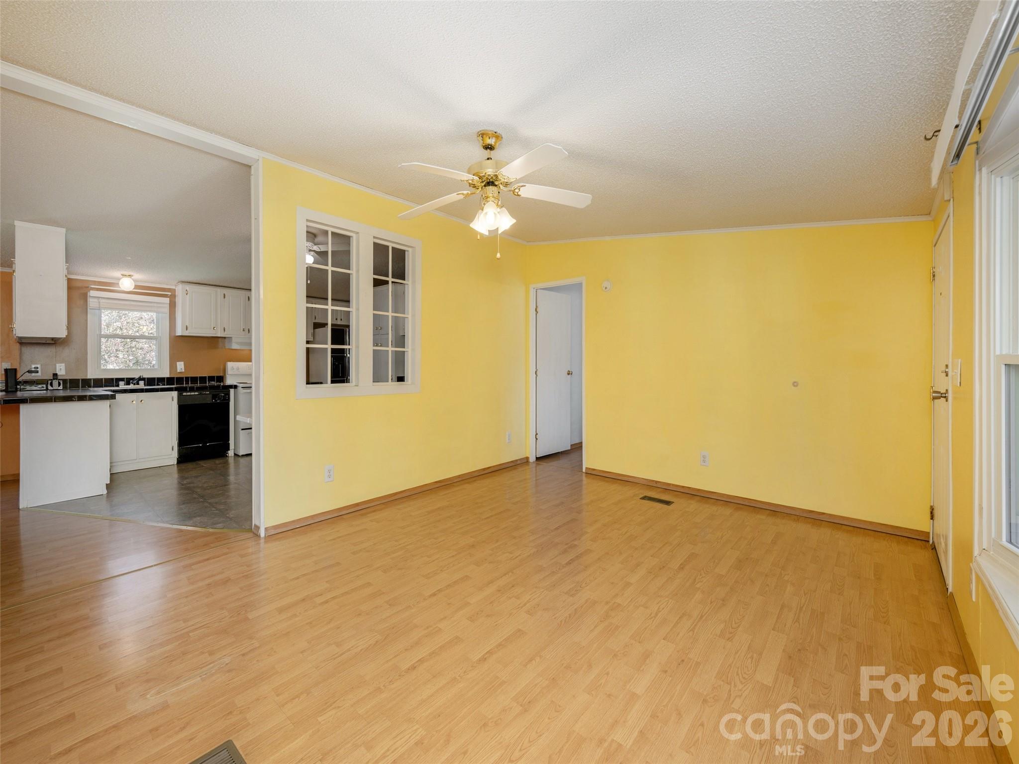 204 Cookies Way Arden, NC 28704 - Photo 4 of 22 a view of an empty room with kitchen view and a window