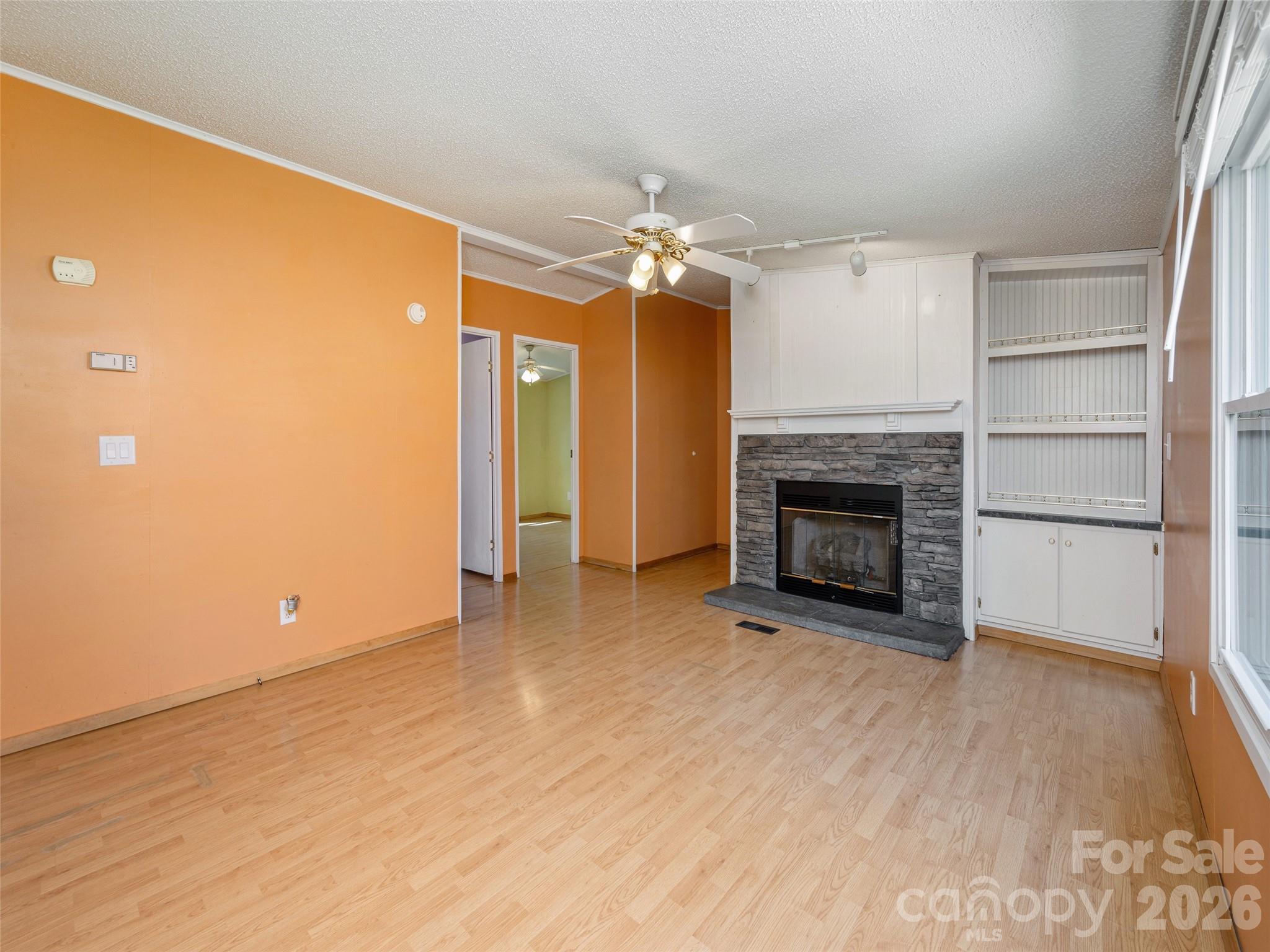 204 Cookies Way Arden, NC 28704 - Photo 5 of 22 a view of empty room with wooden floor and fireplace