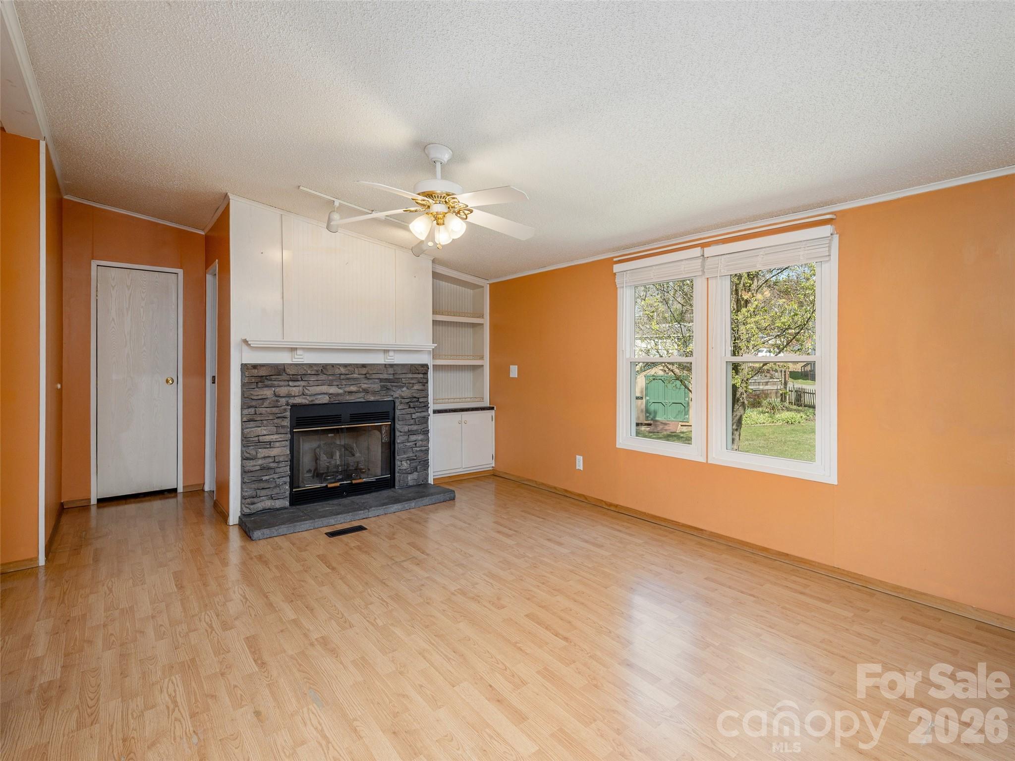204 Cookies Way Arden, NC 28704 - Photo 6 of 22 a view of an empty room with a fireplace and a window