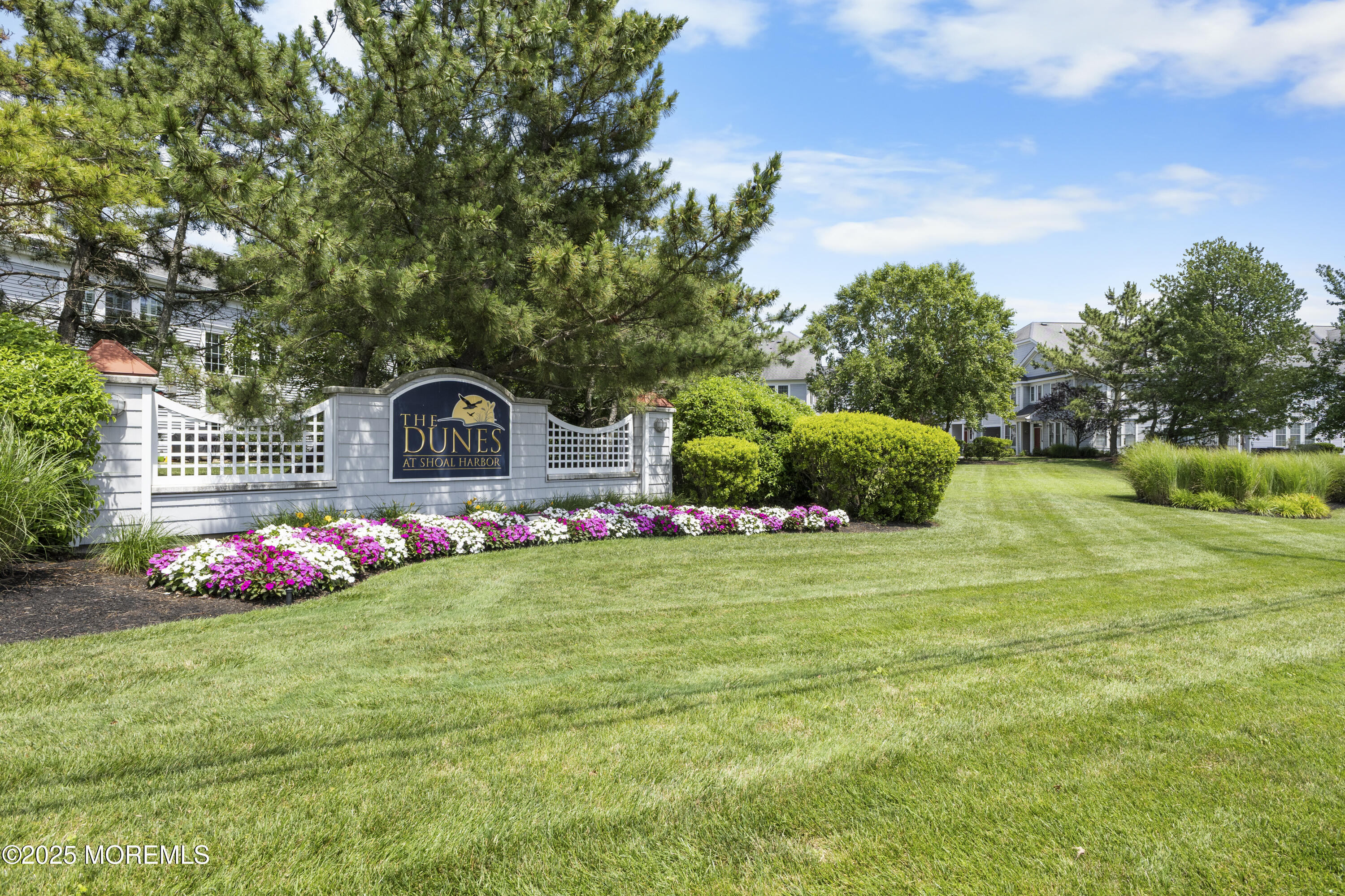 a front view of a house with backyard and garden