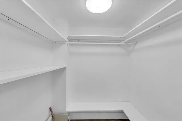 a view of a room with a window and ceiling fan