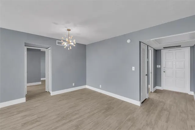 a view of livingroom with hallway and wooden floor