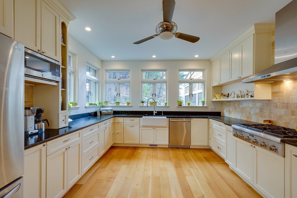 7 Wolcott Road Winchester, MA 01890 - Photo 12 of 41 a kitchen with stainless steel appliances granite countertop a sink and stove