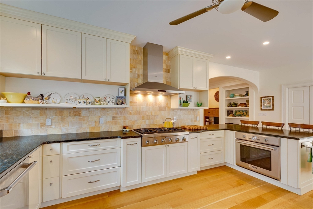 7 Wolcott Road Winchester, MA 01890 - Photo 13 of 41 a kitchen with granite countertop white cabinets and white appliances