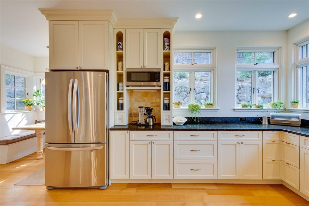 7 Wolcott Road Winchester, MA 01890 - Photo 14 of 41 a kitchen with stainless steel appliances a refrigerator sink and cabinets