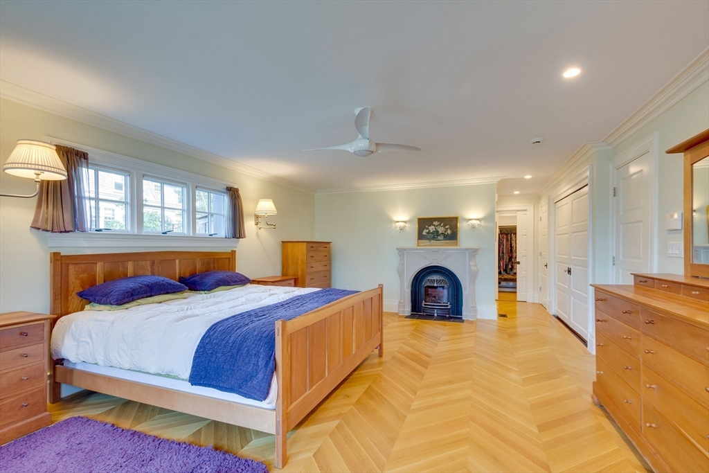 7 Wolcott Road Winchester, MA 01890 - Photo 20 of 41 a bedroom with a bed and a chandelier