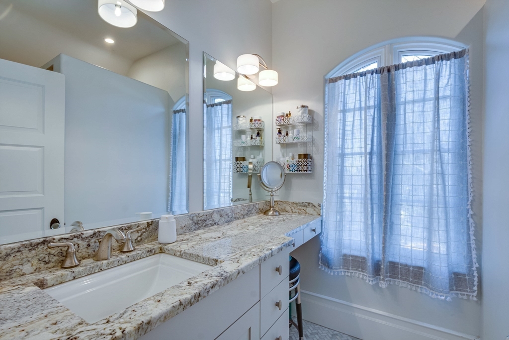 7 Wolcott Road Winchester, MA 01890 - Photo 27 of 41 a bathroom with a granite countertop sink and a mirror