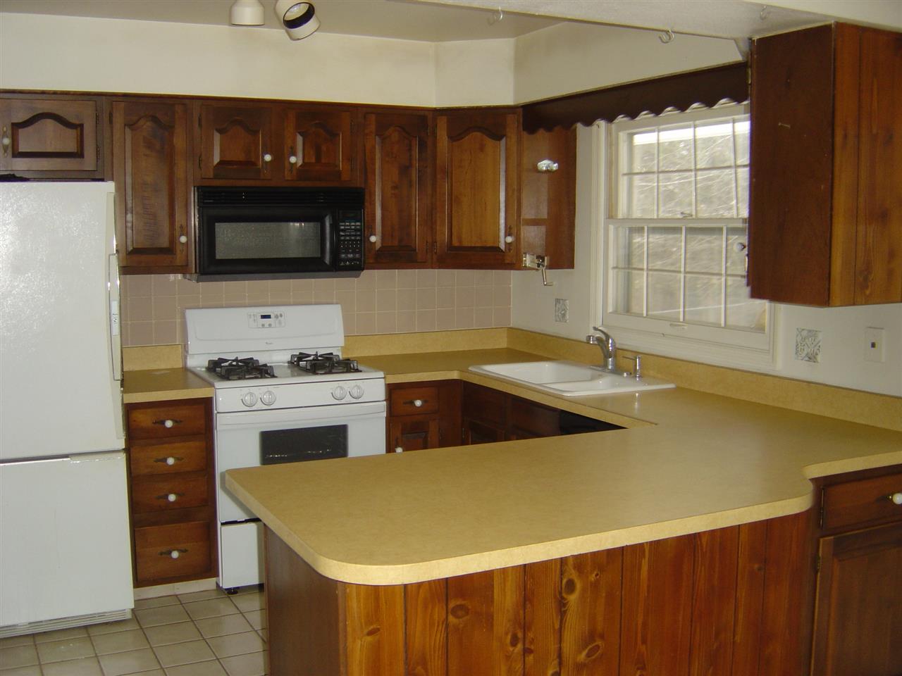 4940 Welsh Road Rockford, IL 61107 - Photo 2 of 12 a kitchen with a sink and a stove top oven