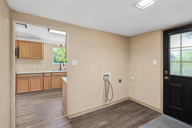 a view of a kitchen with an empty space and a window