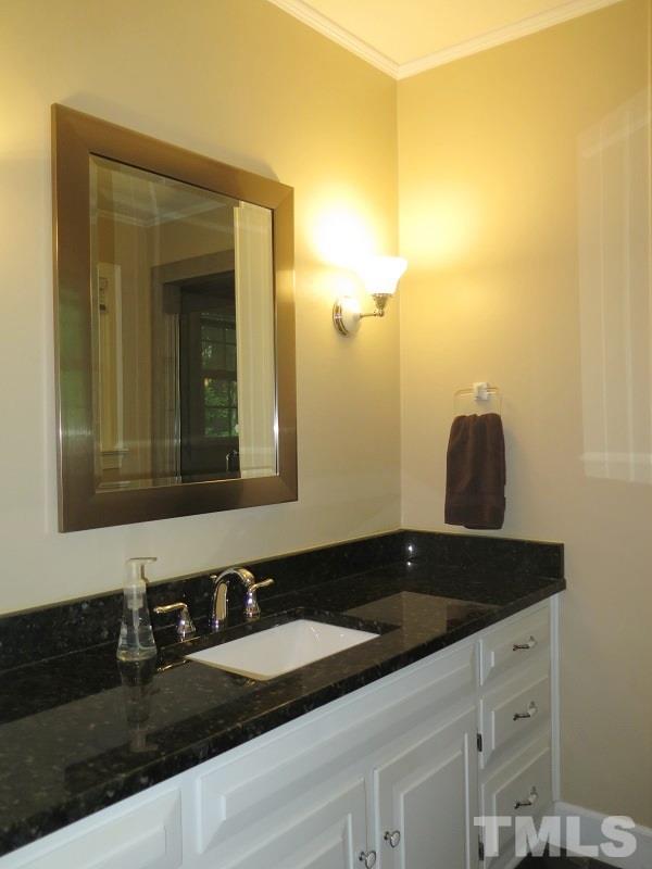 1317 Ravenhurst Drive Raleigh, NC 27615 - Photo 11 of 23 a bathroom with a granite countertop sink and a mirror