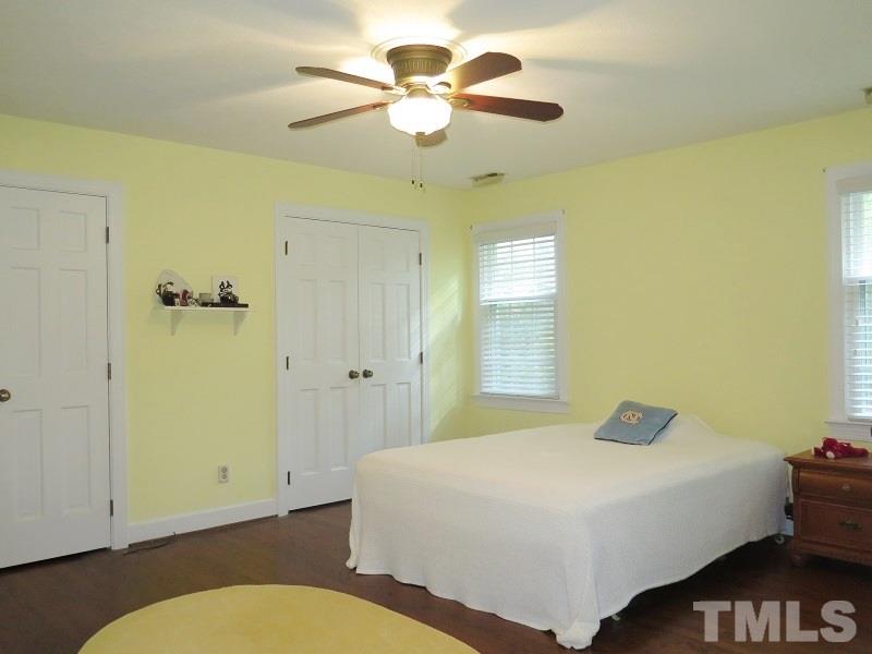 1317 Ravenhurst Drive Raleigh, NC 27615 - Photo 12 of 23 a bedroom with a bed and a chandelier