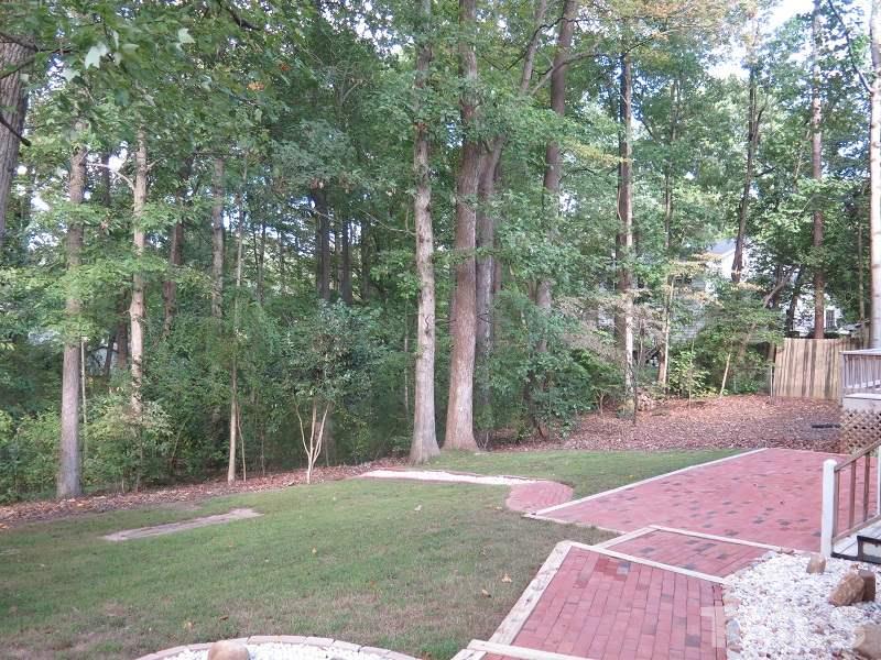 1317 Ravenhurst Drive Raleigh, NC 27615 - Photo 20 of 23 a backyard of a house with lots of green space