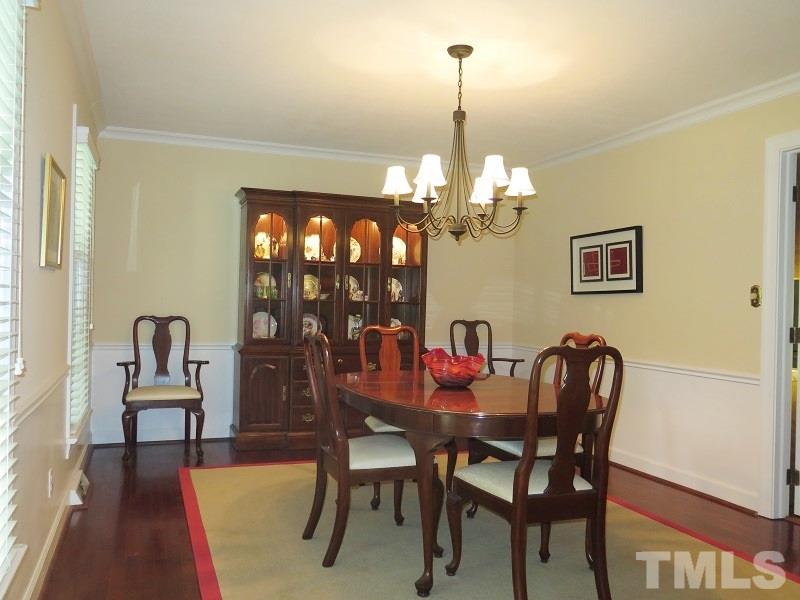 1317 Ravenhurst Drive Raleigh, NC 27615 - Photo 4 of 23 a view of a dining room with furniture and wooden floor