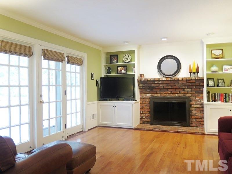 1317 Ravenhurst Drive Raleigh, NC 27615 - Photo 5 of 23 a living room with furniture a fireplace and a flat screen tv