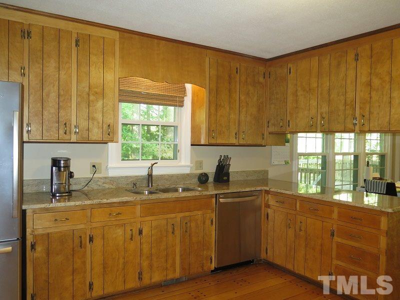 1317 Ravenhurst Drive Raleigh, NC 27615 - Photo 8 of 23 a kitchen with a sink a window and cabinets