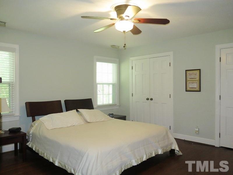 1317 Ravenhurst Drive Raleigh, NC 27615 - Photo 10 of 23 a bedroom with a bed and a chandelier