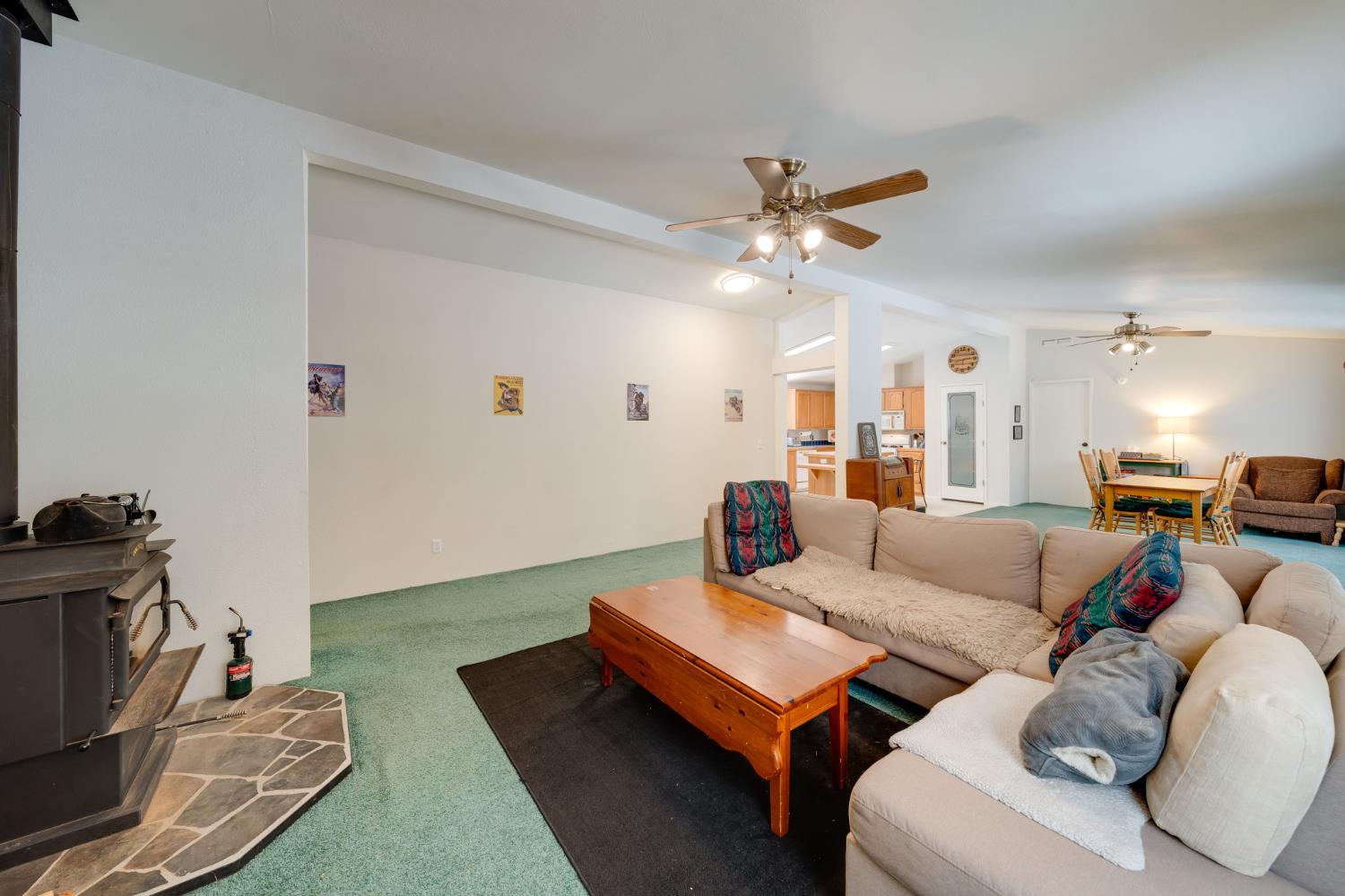 28722 Wood Road Pioneer, CA 95666 - Photo 10 of 39 a living room with furniture a ceiling fan and a rug