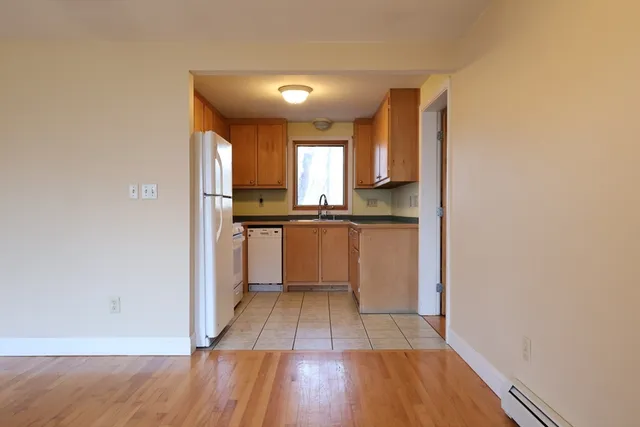 a kitchen with wooden floors and appliances