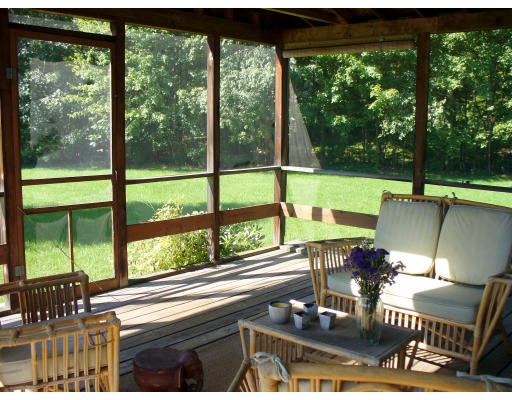 3 Pine Hill Road Easthampton, MA 01027 - Photo 4 of 16 a view of a patio with table chairs and a floor to ceiling window