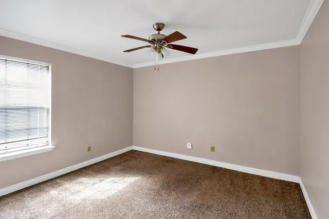 a view of a room with window and ceiling fan