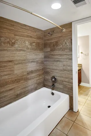 a bathroom with a bathtub and shower