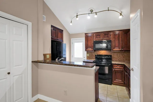 a kitchen with stainless steel appliances a sink stove and cabinets